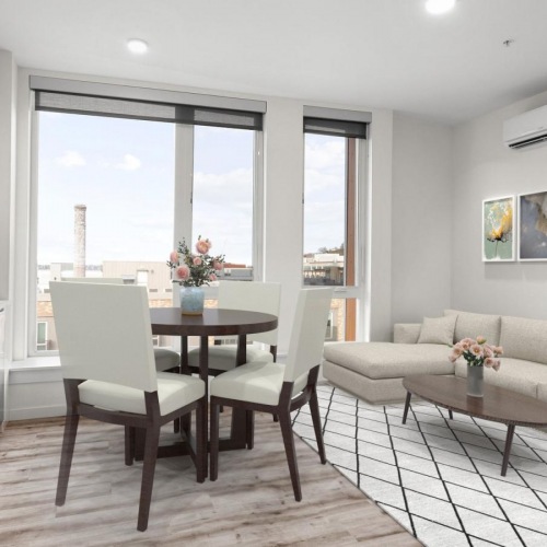 a living room with a table and chairs